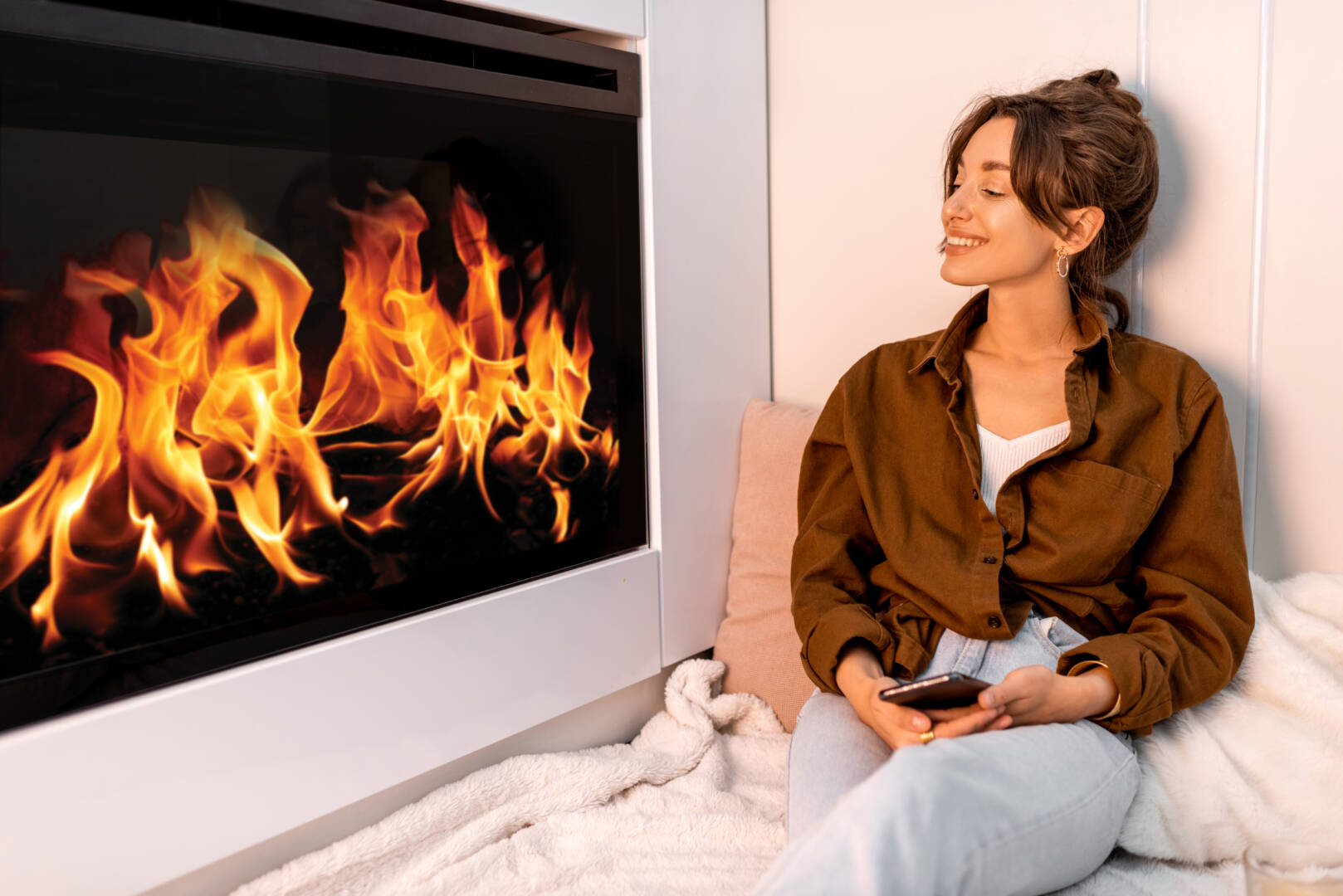 Woman relaxing near the fireplace at home